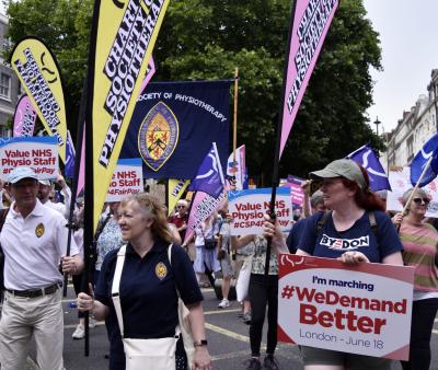 People on a march holding CSP banners