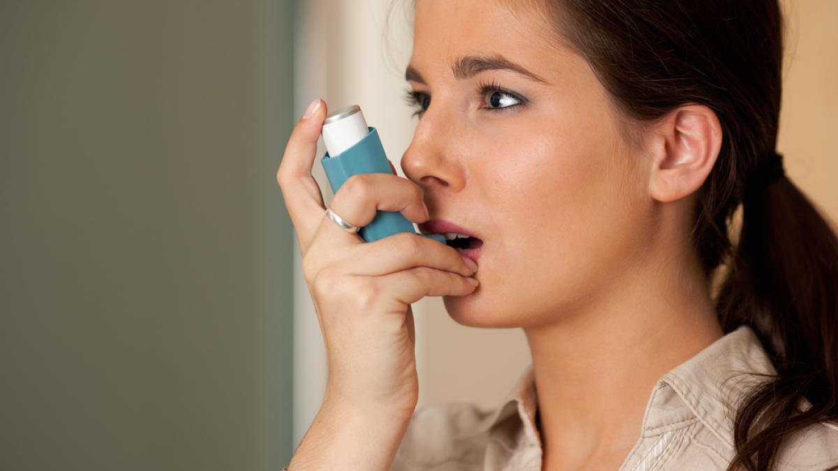 Woman with asthma inhaler